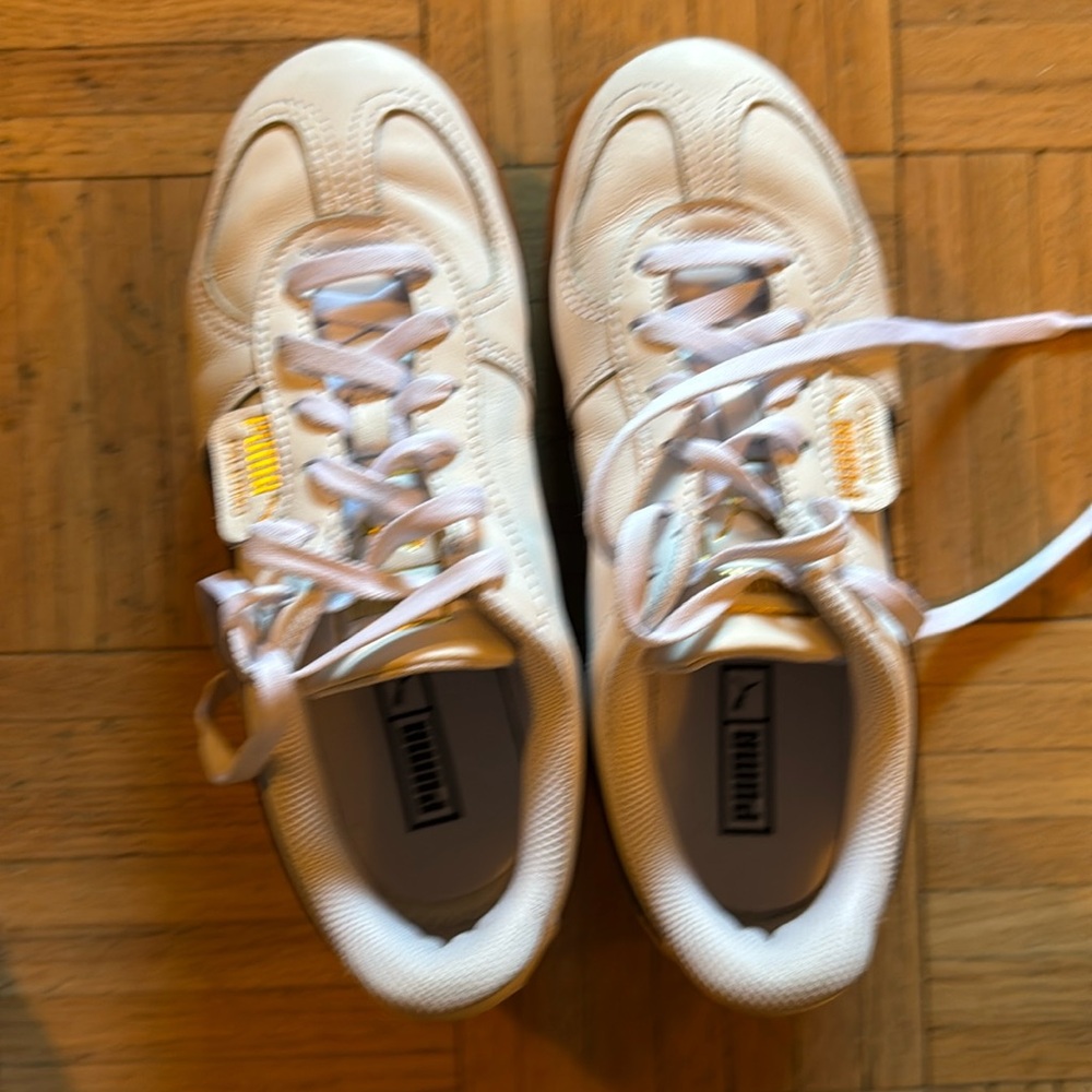 White platform Pumas with black stripe and rubber soles. Lightly worn.